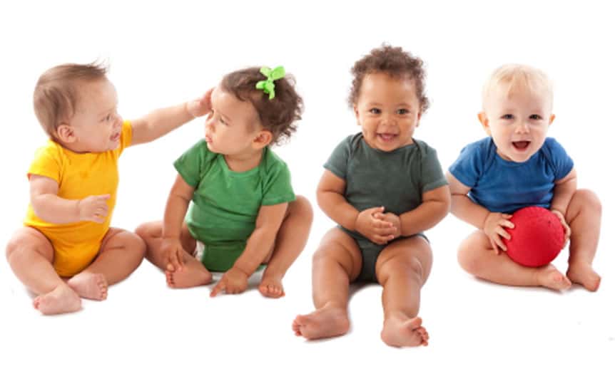 A happy toddler playing with colourful wooden blocks